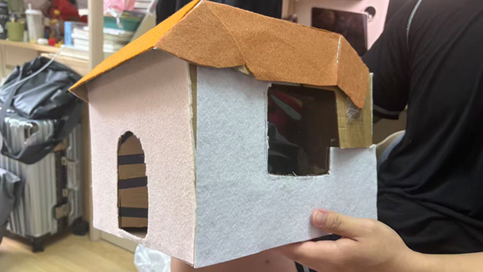 House model with fabric decoration applied